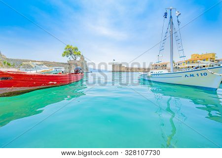 Nafpaktos, Greece - July 22 2019; Picturesque Water Level Image Moored Boats In Fortified Small Medi
