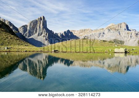 Peaks reflected in Ansabere Lake. Lescun Cirque. Aspe Valley, Pyrenees, France.