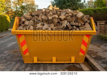 Orange Skip Full Of Bricks And Rubble