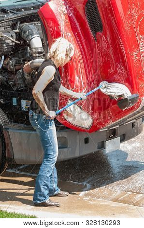 Woman Truck Driver Washing Semi-truck While She Waits For Her D.o.t. 70 Hour Reset.