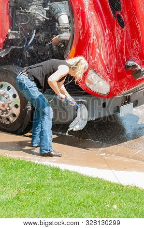 Woman Truck Driver Washing Semi-truck While She Waits For Her D.o.t. 70 Hour Reset.