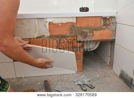 Bathtub Installation And Tiliing With White Ceramic Tiles In House Bath Room