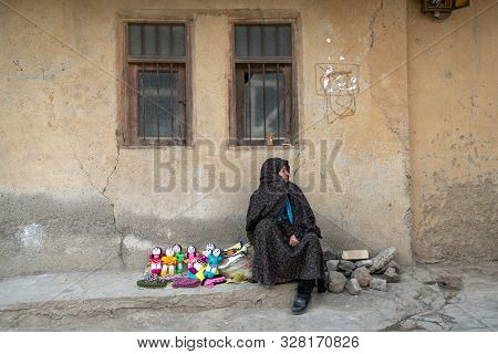 Masuleh, Iran - May 2019: Iranian Woman Selling Hand Made Dolls For Tourists