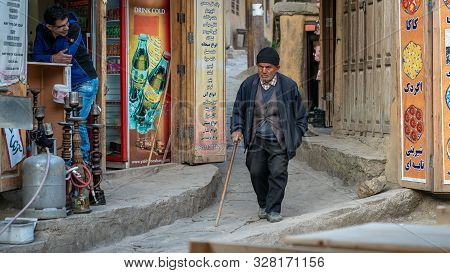 Masuleh, Iran - May 2019: Iranian Old Man Walking In The Narrow Road Of Masuleh Village
