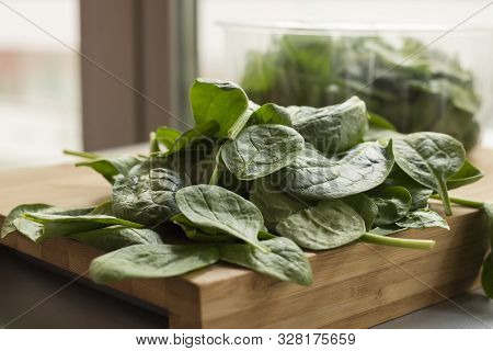 Baby Spinach Leaf On The Kitchen Wooden Board