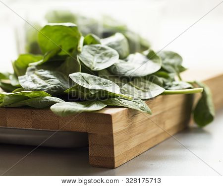 Baby Spinach Leaf On The Kitchen Wooden Board