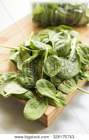 Baby Spinach Leaf On The Kitchen Wooden Board