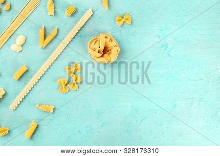 Italian Pasta Variety, Flat Lay Banner, Shot From Above On A Blue Background With Copy Space