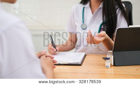 Doctor Giving Medical Advice To Patient.