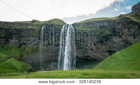 Gljufrabui Waterfall With Unidentified Tourists Walking, Iceland