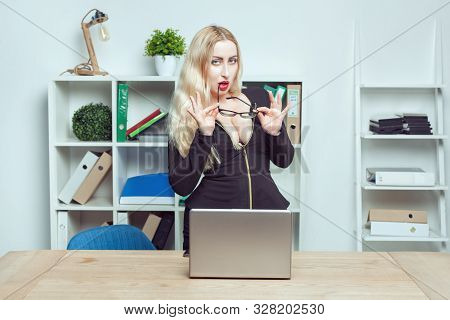 Portrait Of A Sexy Beautiful Secretary Woman In Office. She Holds Glasses In Her Hands.