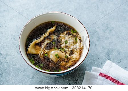 Asian Food Wonton Soup With Bok Choy And Chives In Porcelain Or Ceramic Bowl. Traditional Dish Cuisi