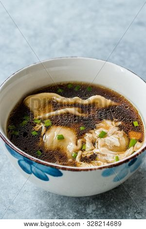 Asian Food Wonton Soup With Bok Choy And Chives In Porcelain Or Ceramic Bowl. Traditional Dish Cuisi