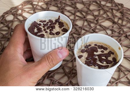 Male Hand Take A Cup With Raw Vegan Chocolate Ice Cream, Made From Bananas, Chocolate And Coconut Cr