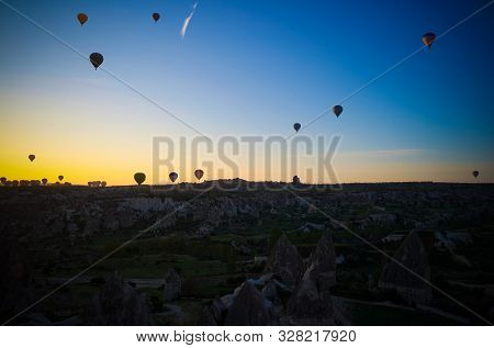 Sunrise Panoramic View To Goreme City And Flying Balloons Over Pigeon Valley Cappadocia, Turkey