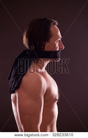 Keep Silent. Profile Of Topless Mature Man Standing With Black Band Covering His Mouth While Looking