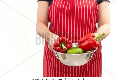 Woman Hands Holding Fresh Sweet Peppers In A Bowl Isolated On White Background.