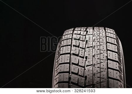 New Non-directional Asymmetric Friction Winter Tire Velcro Without Spikes On Black Background. Rubbe