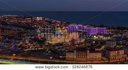 Sochi, Russia - October 2019: Hotel Bogatyr, Sirius And The Ferris Wheel In Night Illumination, From