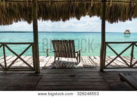 Dock With Chair With View On Lake Itza, El Remate, Guatemala