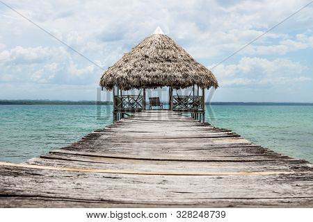 Wooden Dock With Palm Roof Along Lake Itza, El Remate, Guatemala