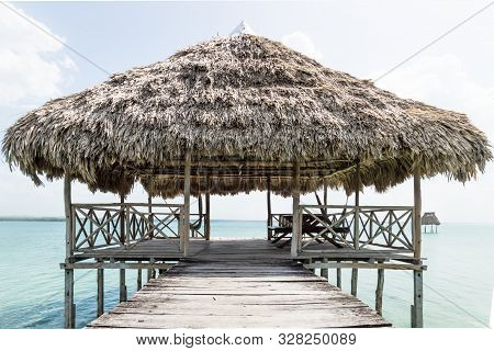 Lake Dock With Relaxing Hammocks At A Sunny Day, El Remate, Guatemala