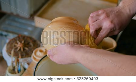 Professional Male Potter Preparing Ceramic Wares For Burning In Pottery Kiln With Milk - Old Russian