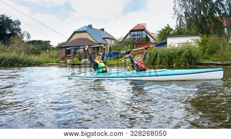 A Girl And A Young Man On A Kayak, Tourists Rafting In A Blue Boat, Matrosovka River, Polessky Distr