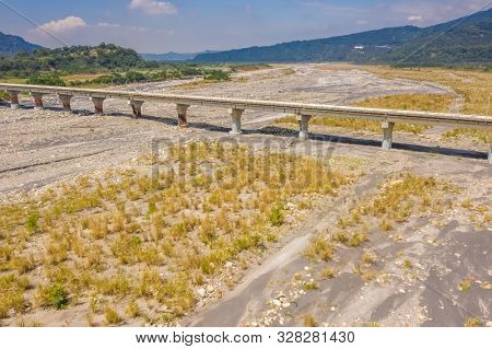 bridge over river with golden miscanthus under sky