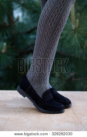 Close-up Of A Young Woman Stand In Peak, Wear In Black Leather Classics Shoes. Outside Image.