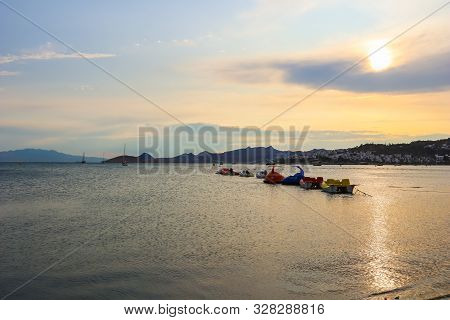 Beautiful Sunset On Mediterranean Coast With Islands And Mountains, Boats And Catamarans