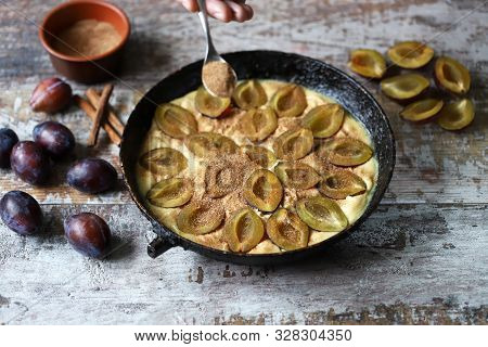Making Plum Pie With Sugar And Cinnamon. American Plum Pie.