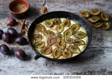 Making Plum Pie With Sugar And Cinnamon. American Plum Pie.