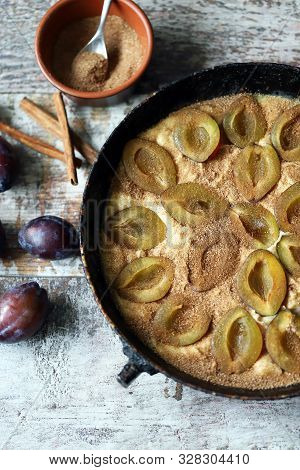 Making Plum Pie With Sugar And Cinnamon. American Plum Pie.