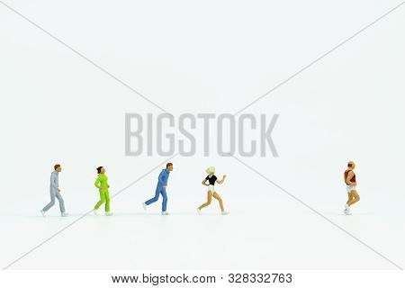 Close Up Miniature People Running On White Background