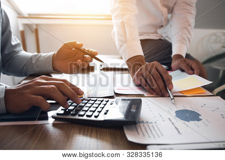 Managers Using Calculator To Analyze Sales Cost Reports And Explain Summary Reports To Employees Cal