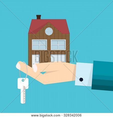Male Hand In Suit - Agent With Home In Palm And House Key On Finger. Offer Of Purchase House, Sale, 