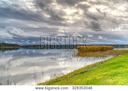 Beautiful Cloudscape Over The Sea From Green Grass. Baltic Sea Hdr