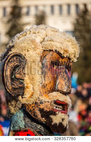 Mummers perform rituals to scare evil spirits at Surva festival at Pernik in Bulgaria. The people with the masks are called Kuker (kukeri). Wood mask with wool beard.