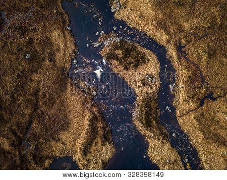 Scottish Winter Wetlands With Brown Grass Over Looking Black Mount Mountain Range On A Cloudy Day In