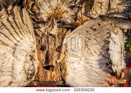Mummers perform rituals to scare evil spirits at Surva festival at Pernik in Bulgaria. The people with the masks are called Kuker (kukeri). Wood mask and feathers.