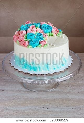 Gorgeous Cake Covered In Bright Roses Made Of Butter Cream Icing On Light Wooden Background