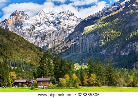 Colorful Wooden Houses In Kandersteg Village, Canton Bern, Switzerland, Europe And Snow Mountains Pa