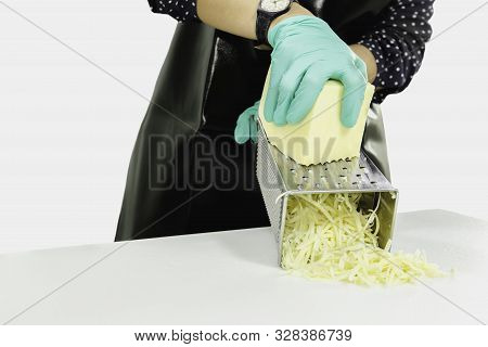 Woman Grating Cheese On Kitchen Table Isolated In Clipping Path.