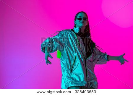 Young Stylish Girl Dancing In The Studio On A Colored Neon Background. Music Poster Design.