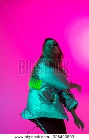 Young Stylish Girl Dancing In The Studio On A Colored Neon Background. Music Poster Design.