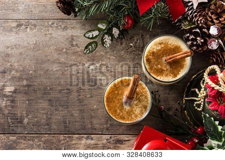Homemade Eggnog With Cinnamon In Glass On Wooden Table. Typical Christmas Dessert. Top View. Copy Sp