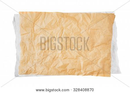 Crumpled Piece Of Brown Baking Paper Over White Paper Or Parchment Isolated On White Background. Top