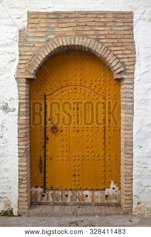Old wooden door with decoration in the medina of Asilah, Morocco