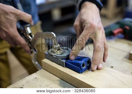 Carpenter Installs The Furniture Hinge. Pocket Hole Joinery Concept.
